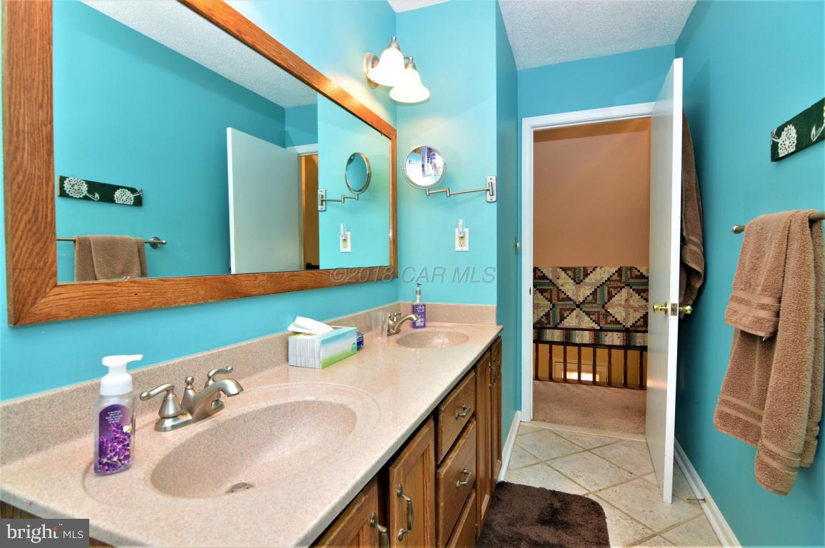 1 Mist Flower Road Ocean Pines, MD 21811 - Photo 40 of 66 a bathroom with a sink double vanity and a mirror