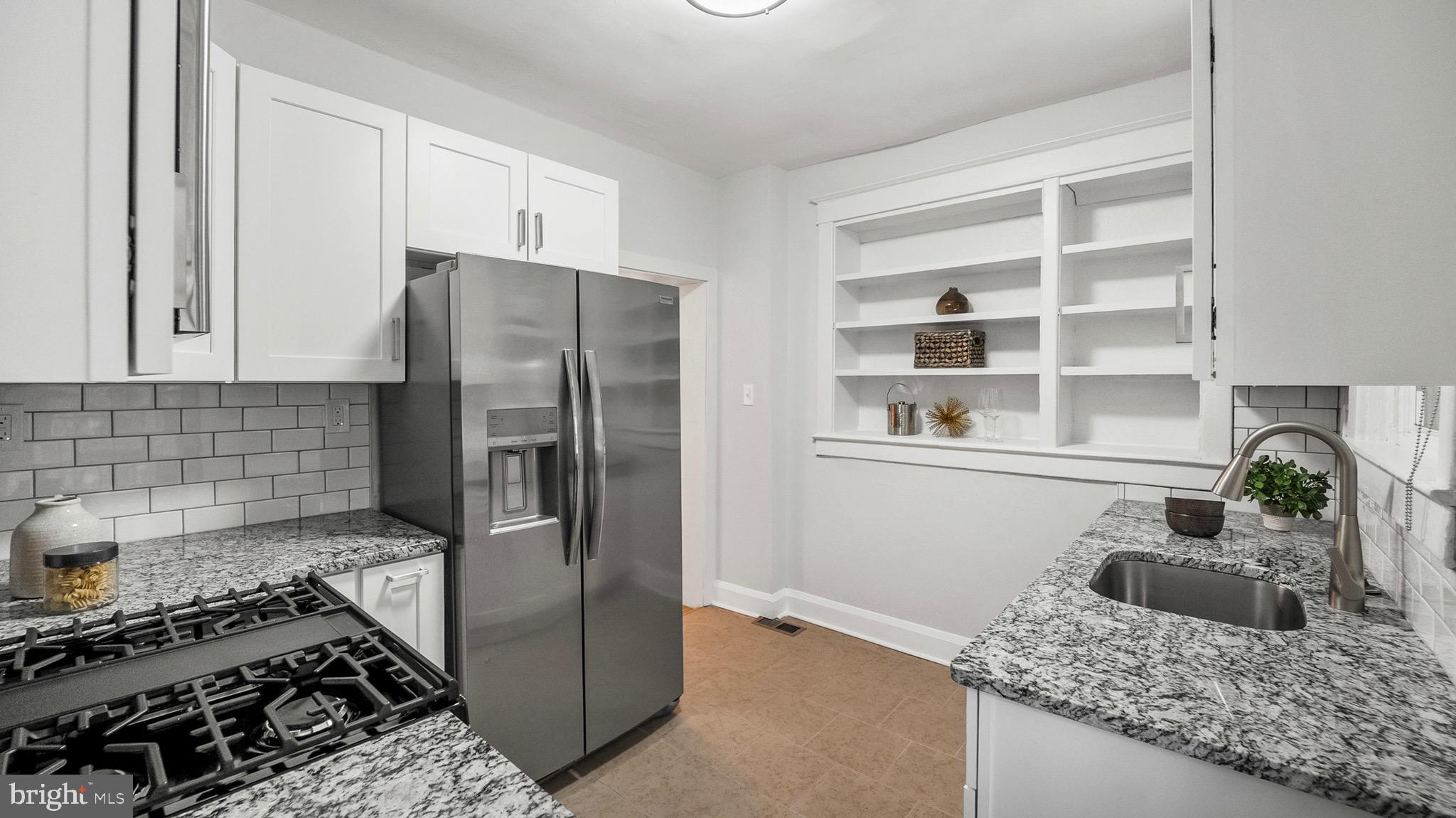27 North Monastery Avenue Baltimore, MD 21229 - Photo 11 of 26 a kitchen with a refrigerator and a stove