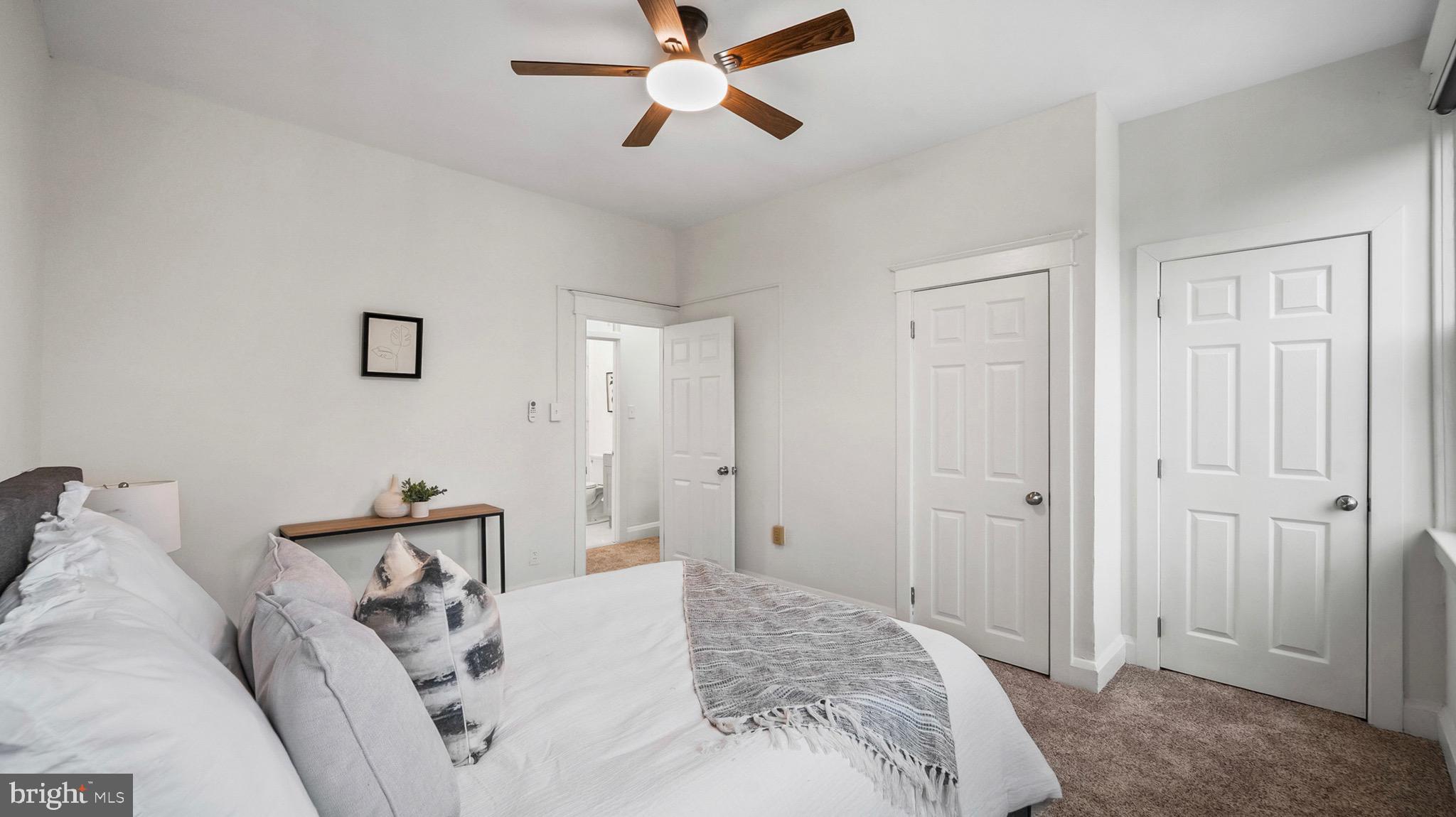 27 North Monastery Avenue Baltimore, MD 21229 - Photo 12 of 26 a spacious bedroom with a bed and a chandelier