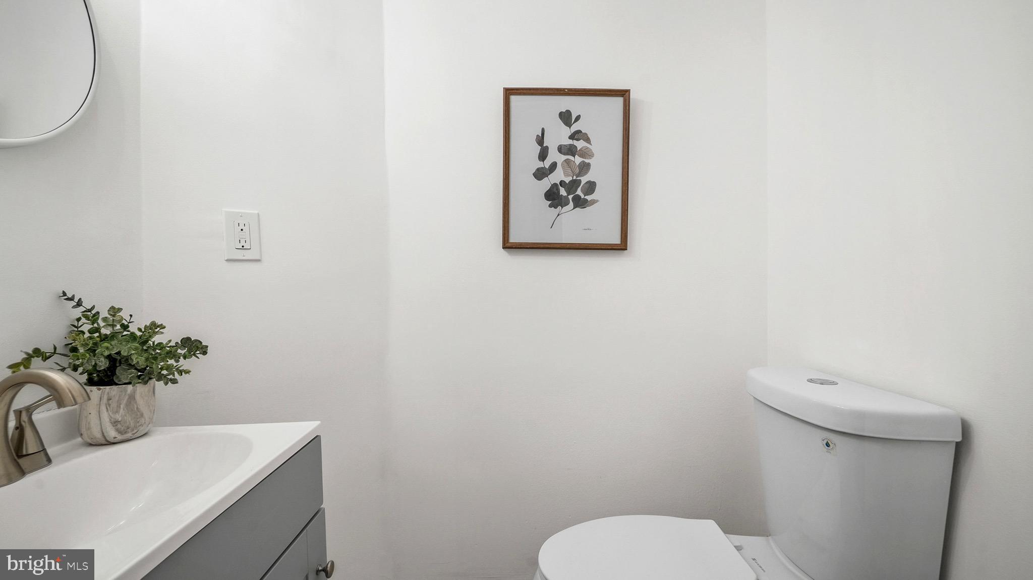 27 North Monastery Avenue Baltimore, MD 21229 - Photo 15 of 26 a bathroom with a toilet a sink and mirror