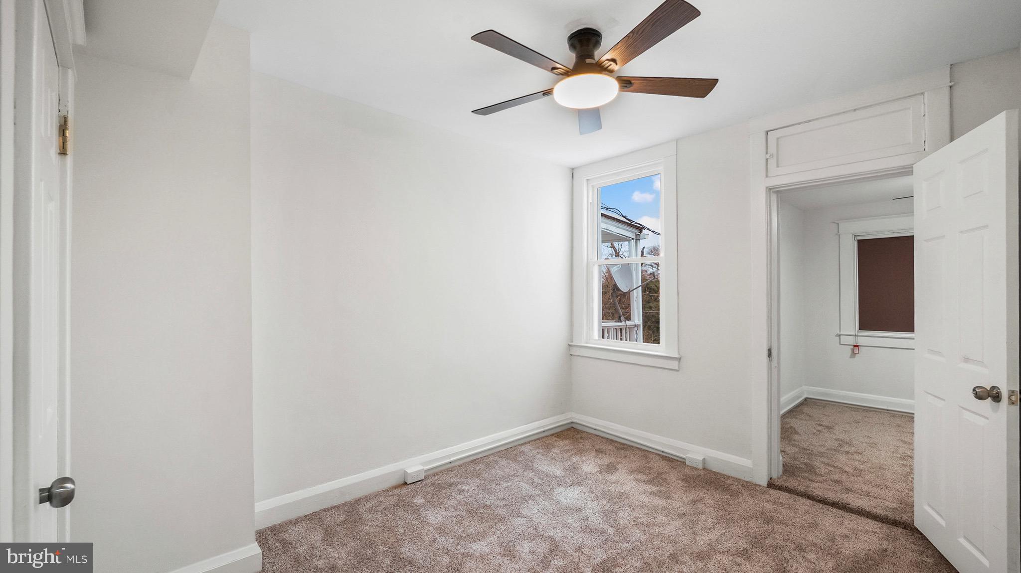 27 North Monastery Avenue Baltimore, MD 21229 - Photo 19 of 26 an empty room with window and ceiling fan