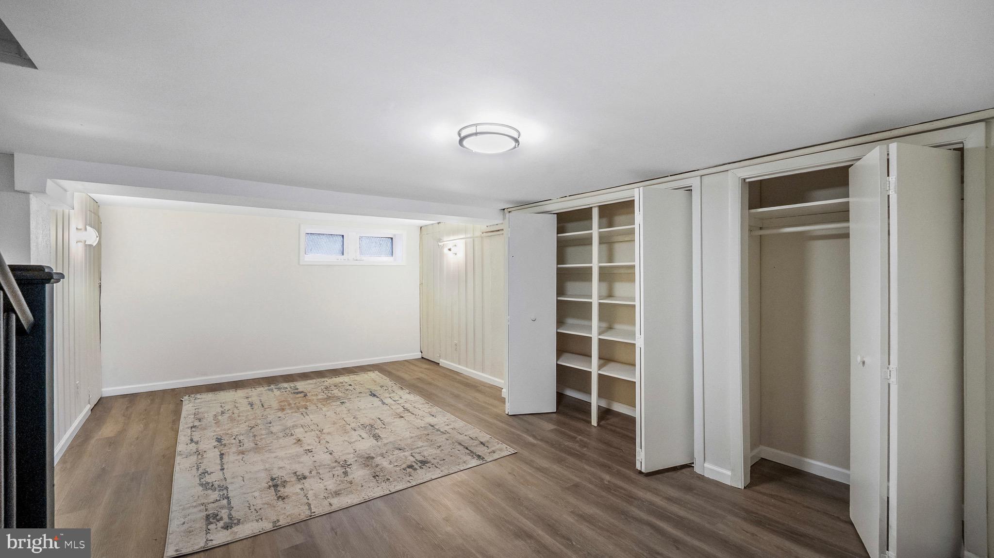 27 North Monastery Avenue Baltimore, MD 21229 - Photo 21 of 26 an empty room with a wooden floor and closet