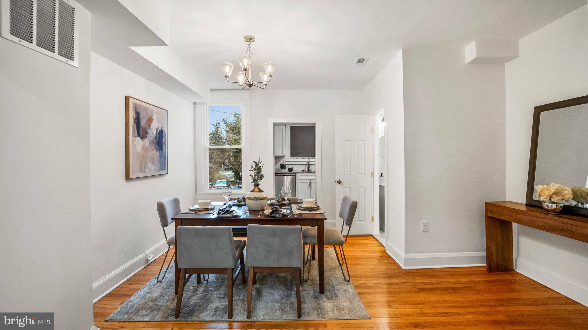 27 North Monastery Avenue Baltimore, MD 21229 - Photo 8 of 26 a dining room with furniture a chandelier and wooden floor