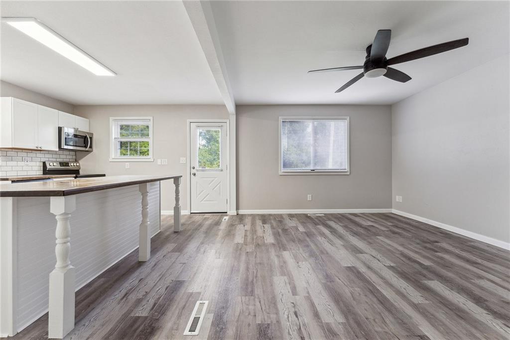 352 Walnut Hill Road Uniontown, PA 15401 - Photo 27 of 30 a view of a kitchen from the hallway with a window and wooden floor