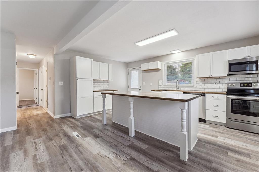 352 Walnut Hill Road Uniontown, PA 15401 - Photo 29 of 30 a kitchen with kitchen island granite countertop a sink cabinets and stainless steel appliances