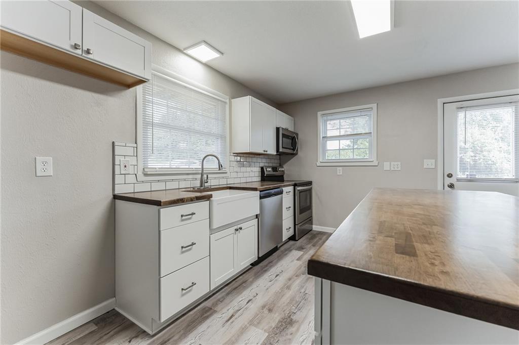 352 Walnut Hill Road Uniontown, PA 15401 - Photo 6 of 30 a kitchen with granite countertop white cabinets and white appliances
