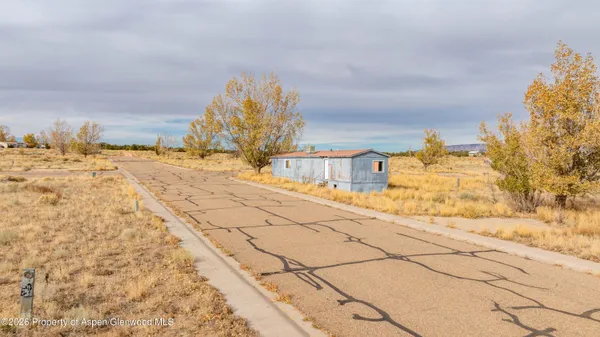 a view of a yard with snow on the road