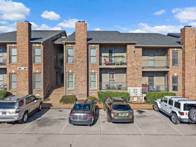a car parked in front of a brick building