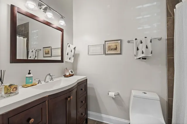 a bathroom with a sink vanity and mirror