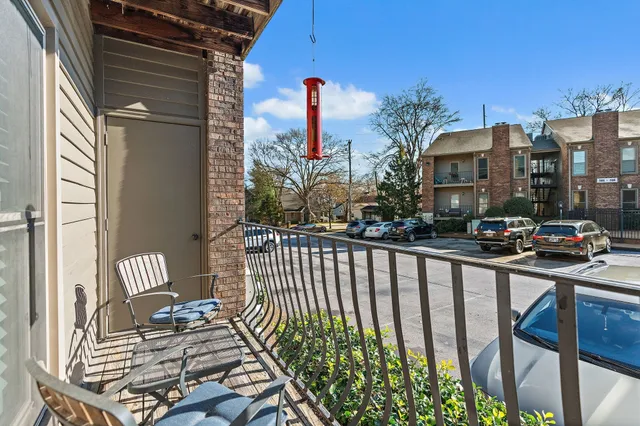 a view of a balcony with two chairs and a table