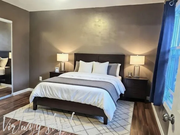 a bedroom with a bed and a mirror