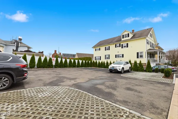 a view of a white house with a street view