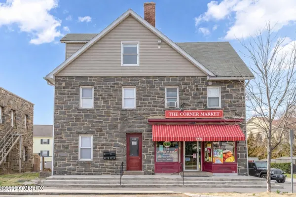 a front view of multi story residential apartment building with retail shop and retail shops