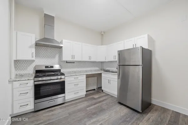 a kitchen with a stove and a refrigerator