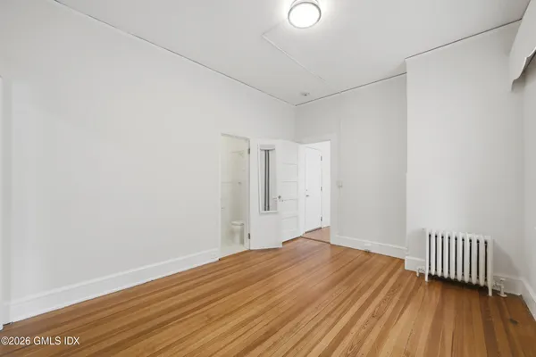 a view of a room with wooden floor and a window
