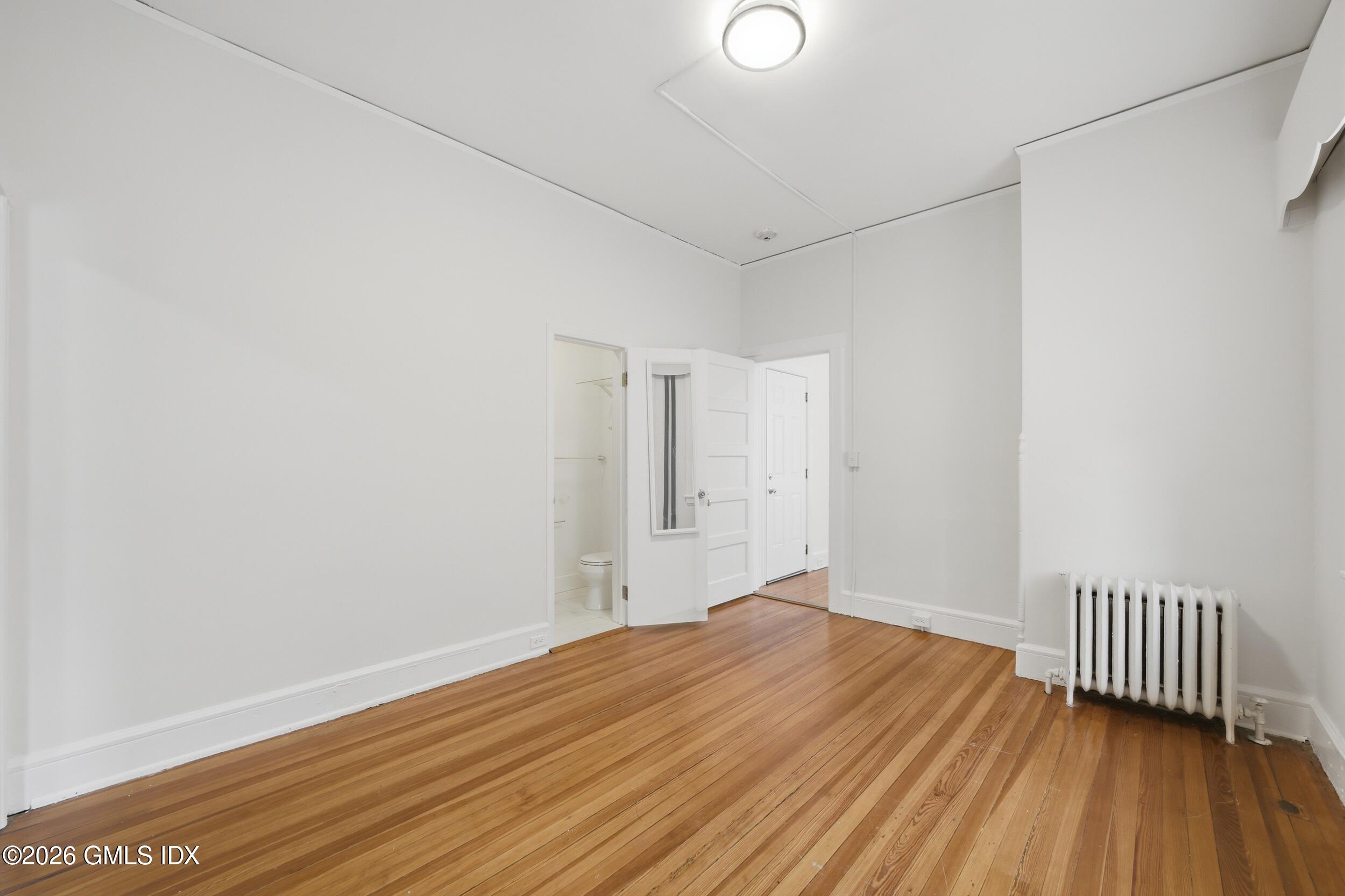 140 Hamilton Avenue, Unit 1 Greenwich, CT 06830 - Photo 6 of 14 a view of a room with wooden floor and a window