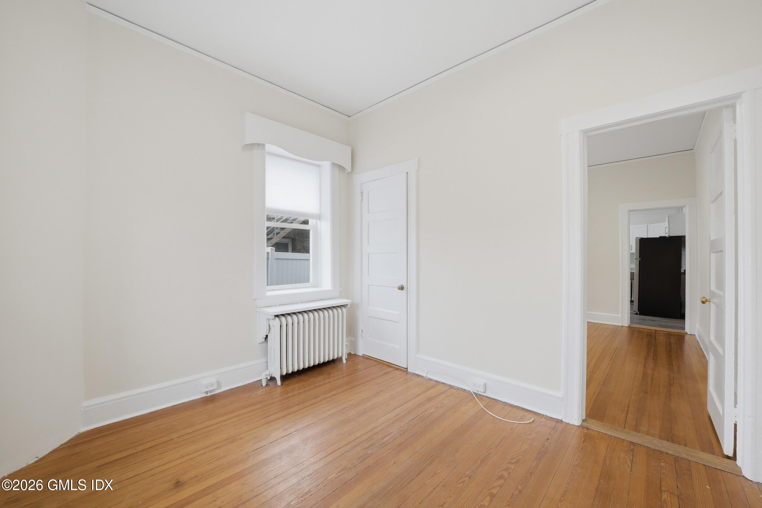 140 Hamilton Avenue, Unit 1 Greenwich, CT 06830 - Photo 8 of 14 an empty room with wooden floor and cabinet