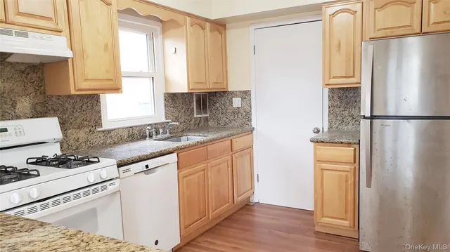 a kitchen with stainless steel appliances a refrigerator sink and cabinets