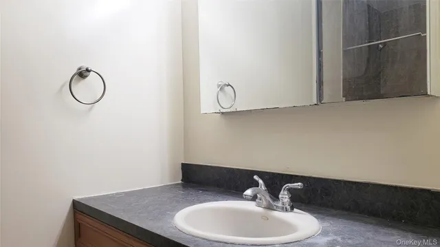 a bathroom with a sink and mirror
