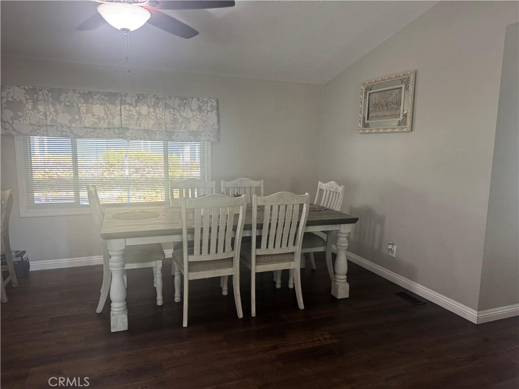 15181 Van Buren Boulevard, Unit 47 Riverside, CA 92504 - Photo 7 of 20 a view of a dining room with furniture and wooden floor