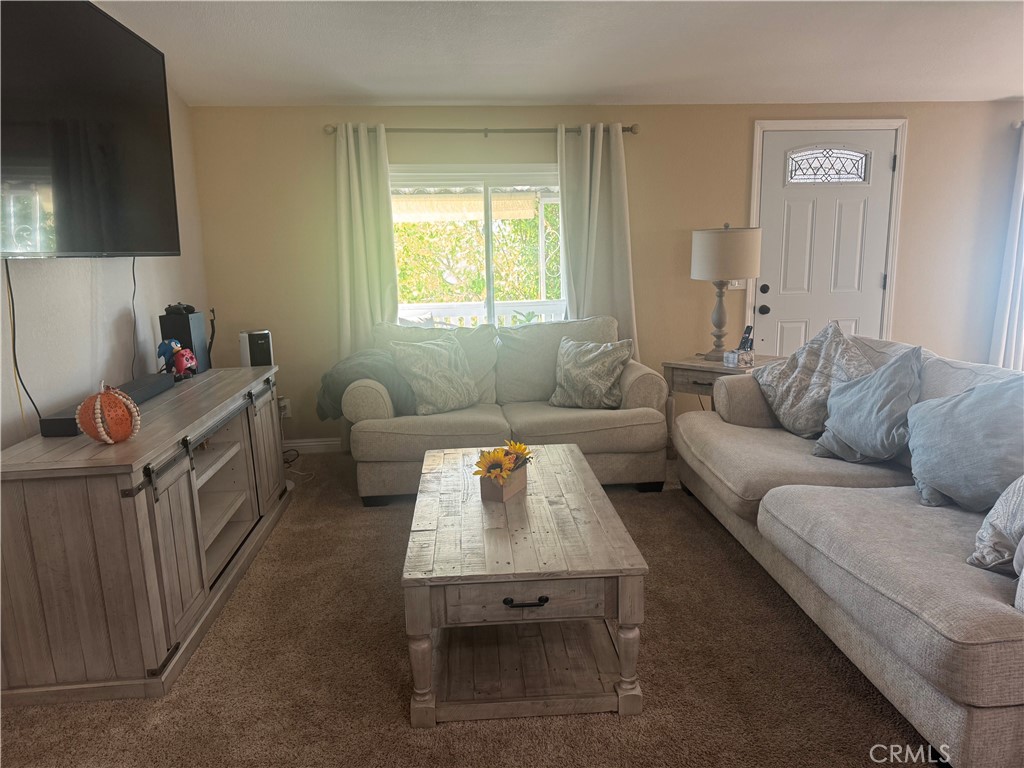 15181 Van Buren Boulevard, Unit 47 Riverside, CA 92504 - Photo 9 of 20 a living room with furniture and a window