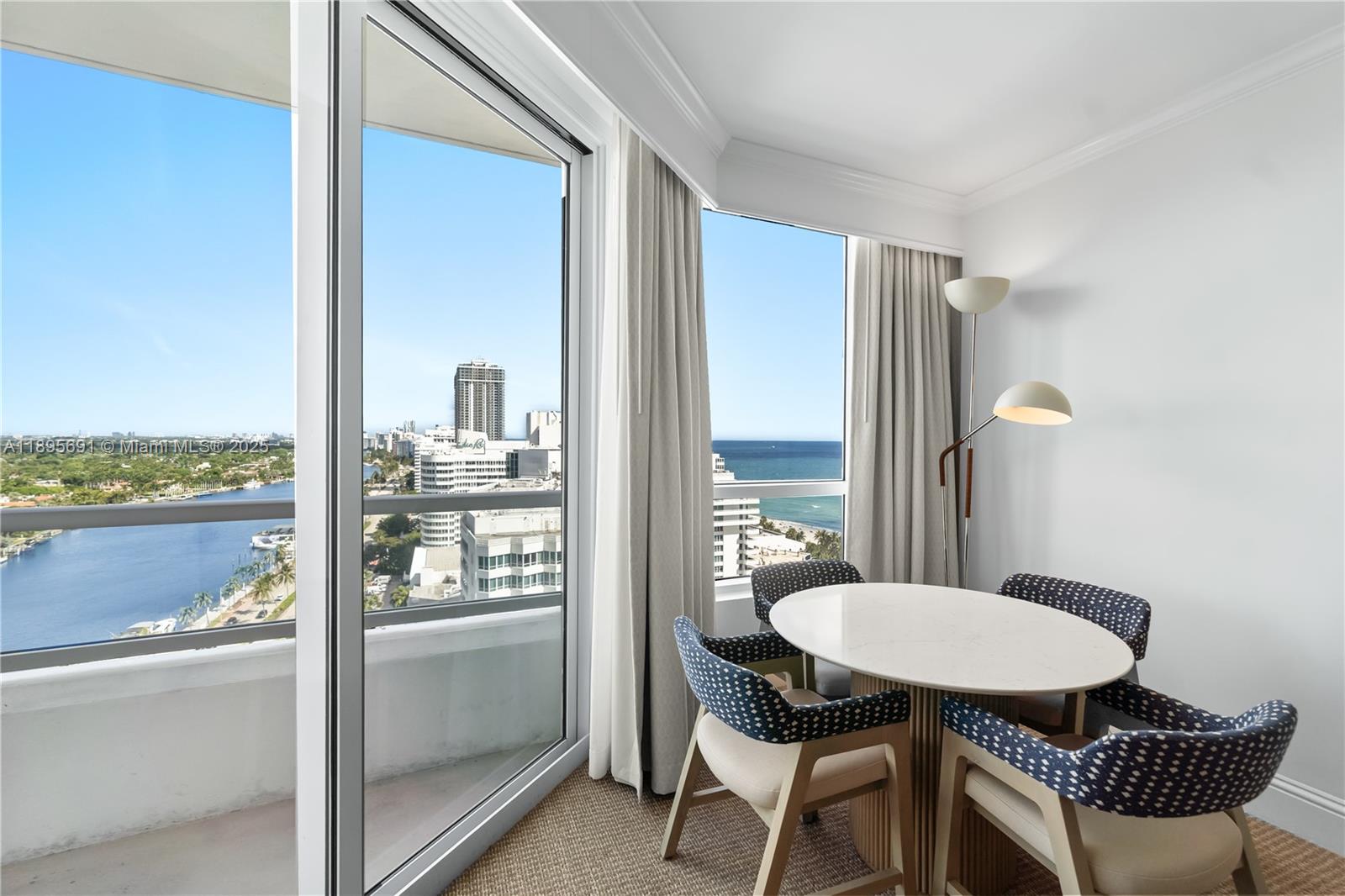4401 Collins Avenue, Unit 2011 Miami Beach, FL 33140 - Photo 11 of 64 a view of a room with a table and chairs