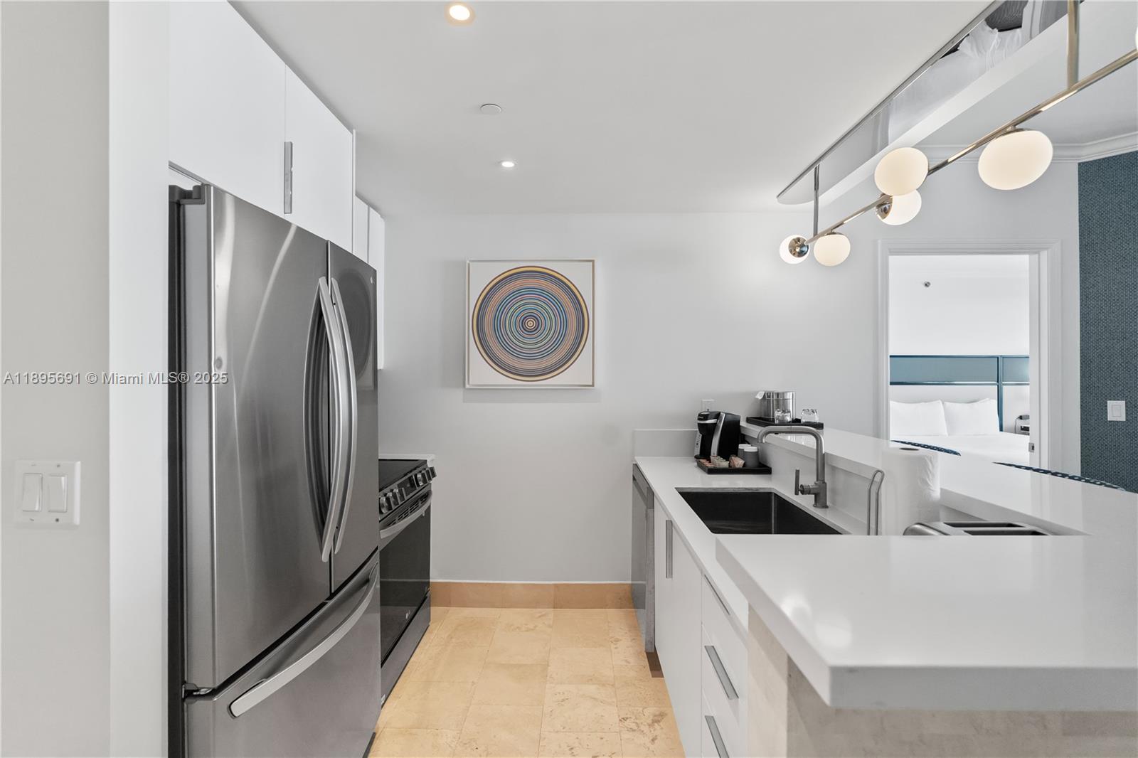 4401 Collins Avenue, Unit 2011 Miami Beach, FL 33140 - Photo 18 of 64 a kitchen with stainless steel appliances granite countertop a refrigerator and a stove