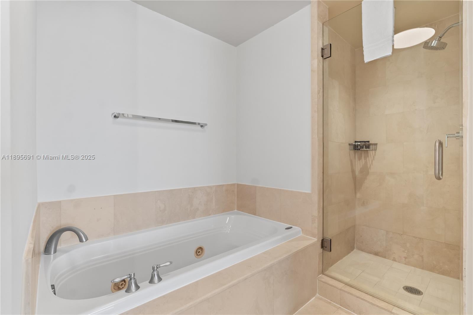 4401 Collins Avenue, Unit 2011 Miami Beach, FL 33140 - Photo 26 of 64 a bathroom with a tub and a shower