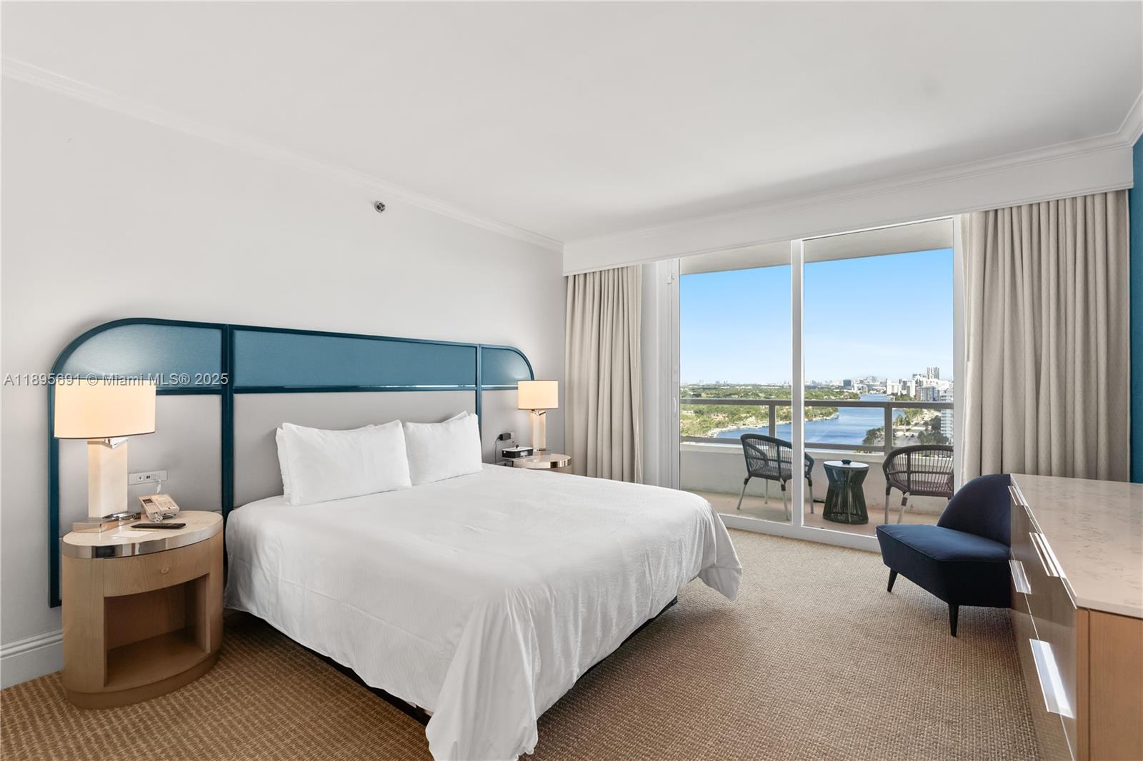 4401 Collins Avenue, Unit 2011 Miami Beach, FL 33140 - Photo 27 of 64 a bedroom with a bed and a view of balcony