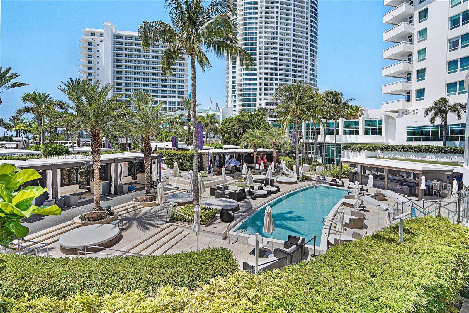 4401 Collins Avenue, Unit 2011 Miami Beach, FL 33140 - Photo 39 of 64 a view of a swimming pool with outdoor seating