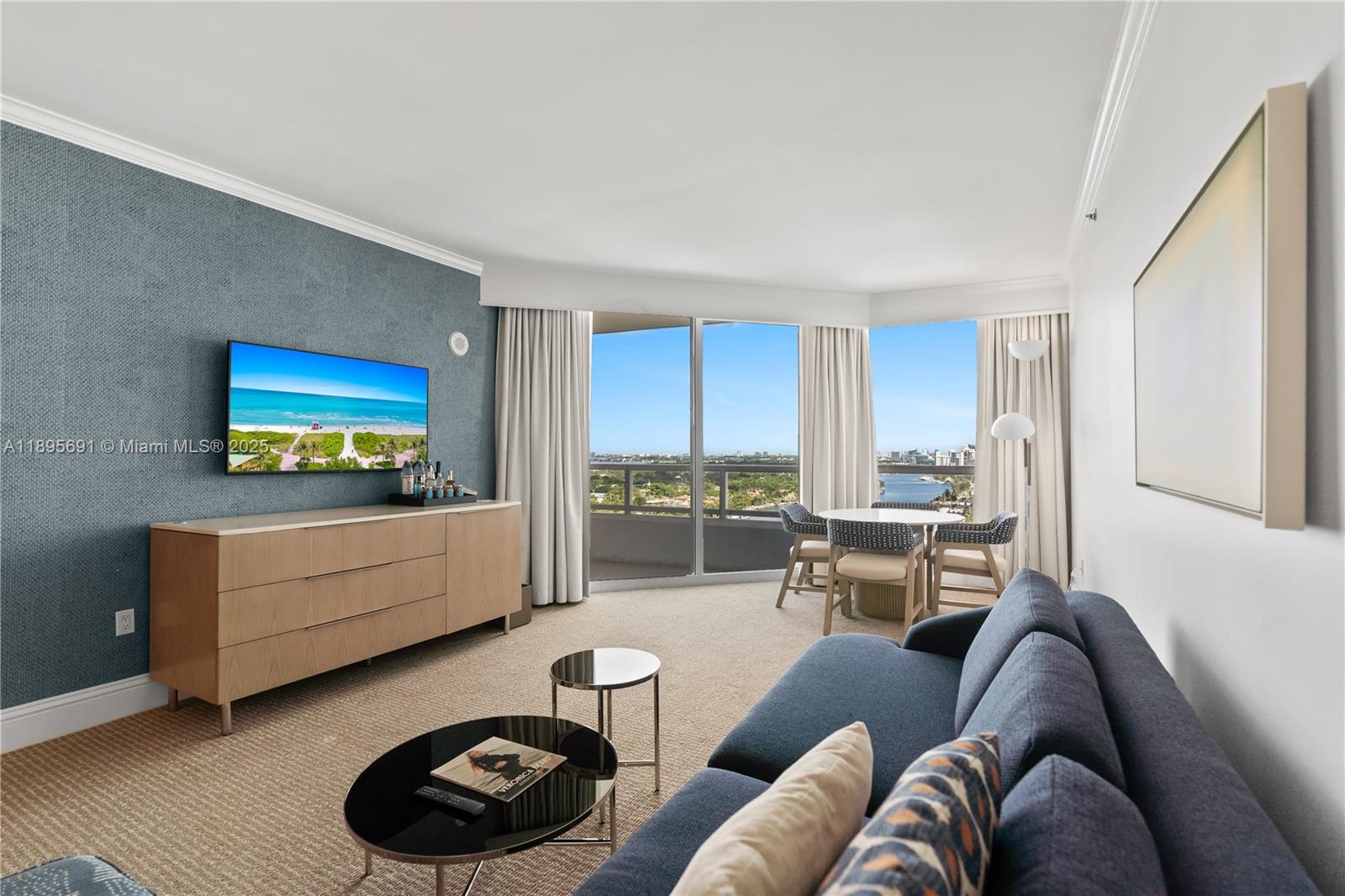 4401 Collins Avenue, Unit 2011 Miami Beach, FL 33140 - Photo 9 of 64 a living room with furniture and a flat screen tv