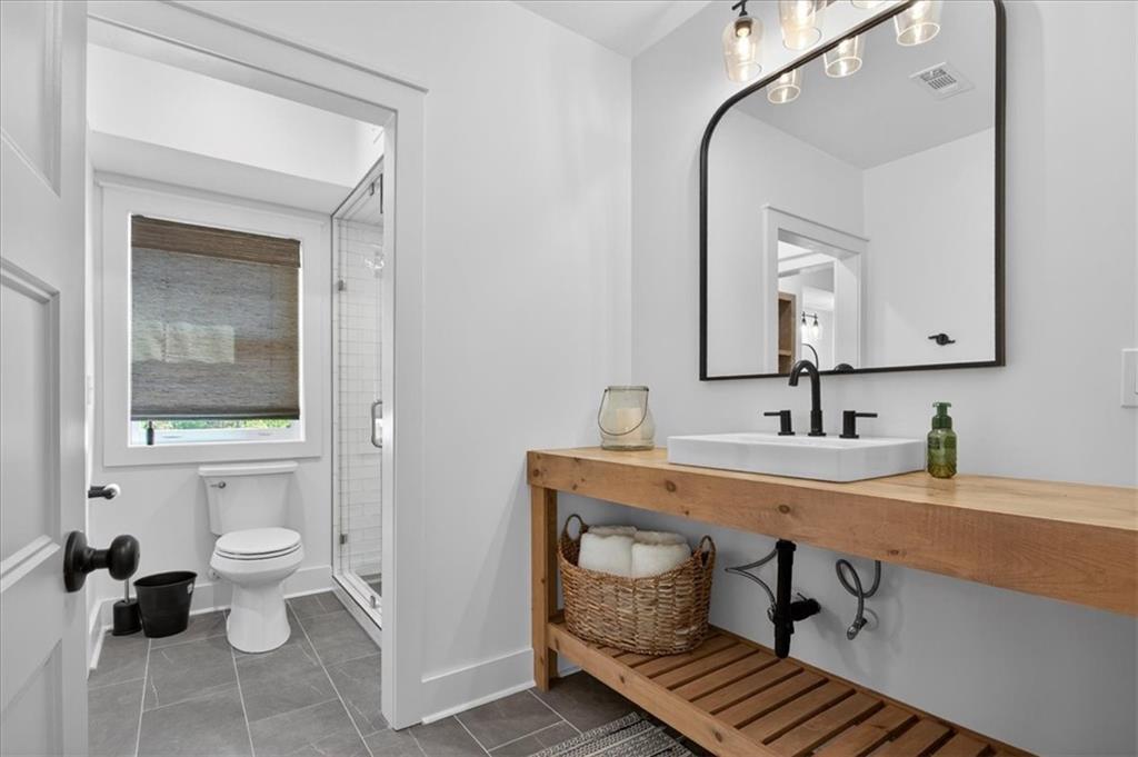 122 Brookfield Court White, GA 30184 - Photo 50 of 63 a bathroom with a toilet sink and mirror