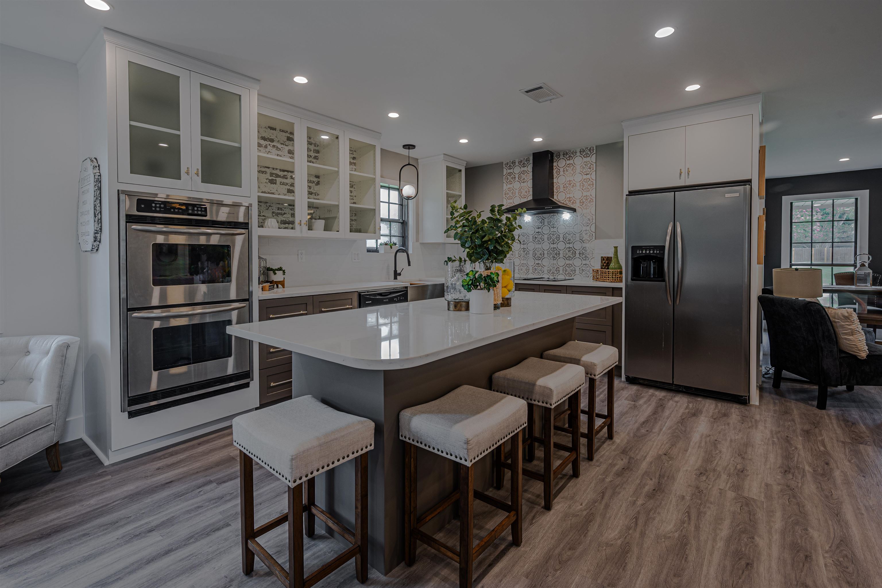 2138 Sonning Drive Germantown, TN 38138 - Photo 14 of 40 a kitchen with stainless steel appliances a dining table chairs and wooden floor