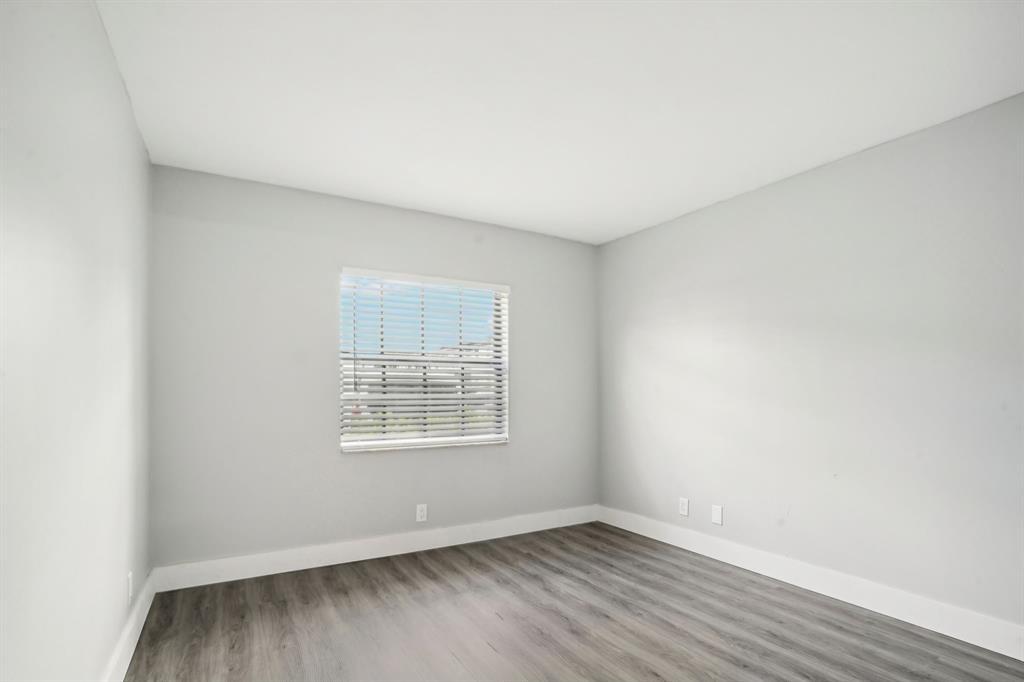 3210 Northwest 84th Avenue, Unit 124 Sunrise, FL 33351 - Photo 7 of 9 an empty room with wooden floor and windows