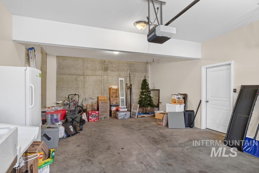 1337 Bristol Road Moscow, ID 83843 - Photo 22 of 28 Spacious garage featuring a concrete floor, exposed concrete wall, a single white door, and an automatic garage door opener