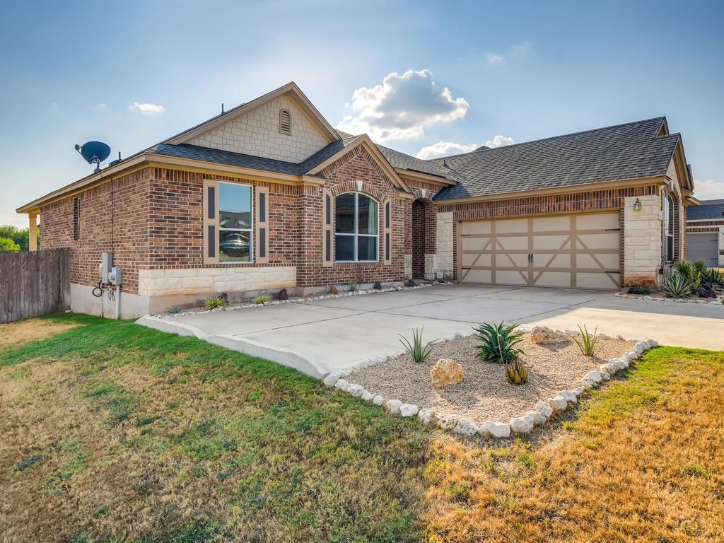a front view of a house with a yard and a garage