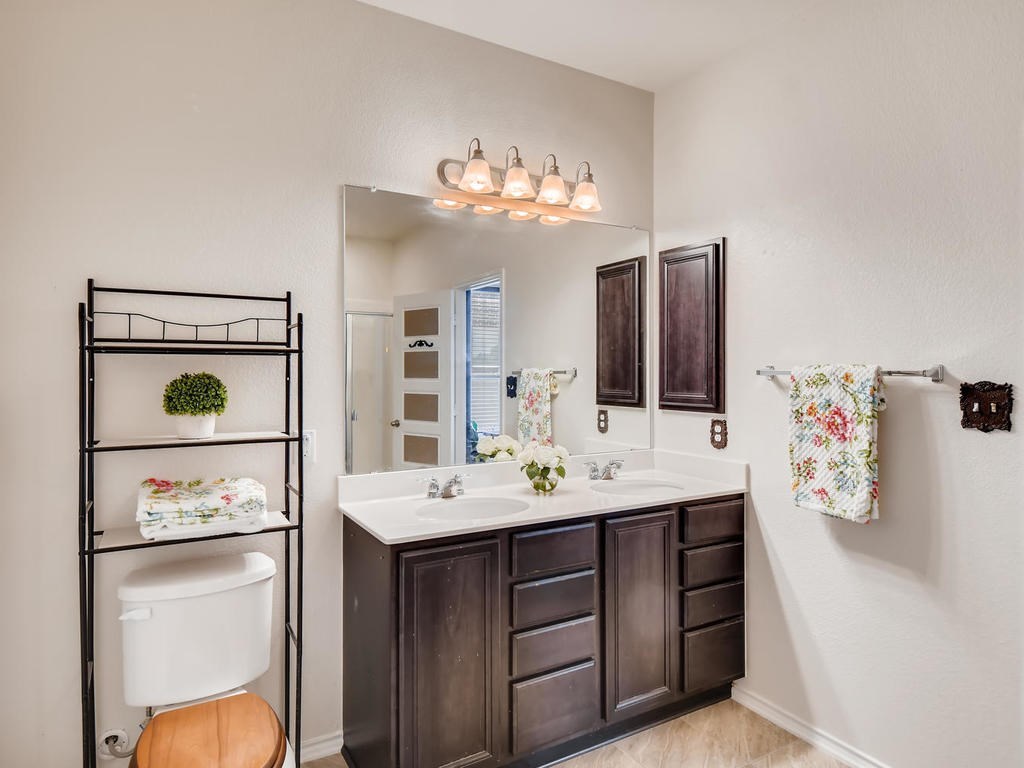 1301 Autumn Sage Way Pflugerville, TX 78660 - Photo 11 of 28 a bathroom with a sink vanity and mirror