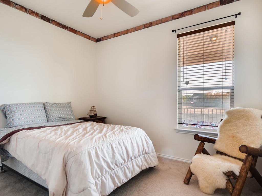 1301 Autumn Sage Way Pflugerville, TX 78660 - Photo 20 of 28 a bedroom with a bed chair and window