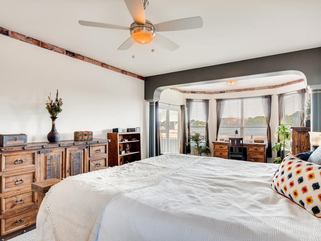 1301 Autumn Sage Way Pflugerville, TX 78660 - Photo 21 of 28 a large bedroom with a large bed and large windows