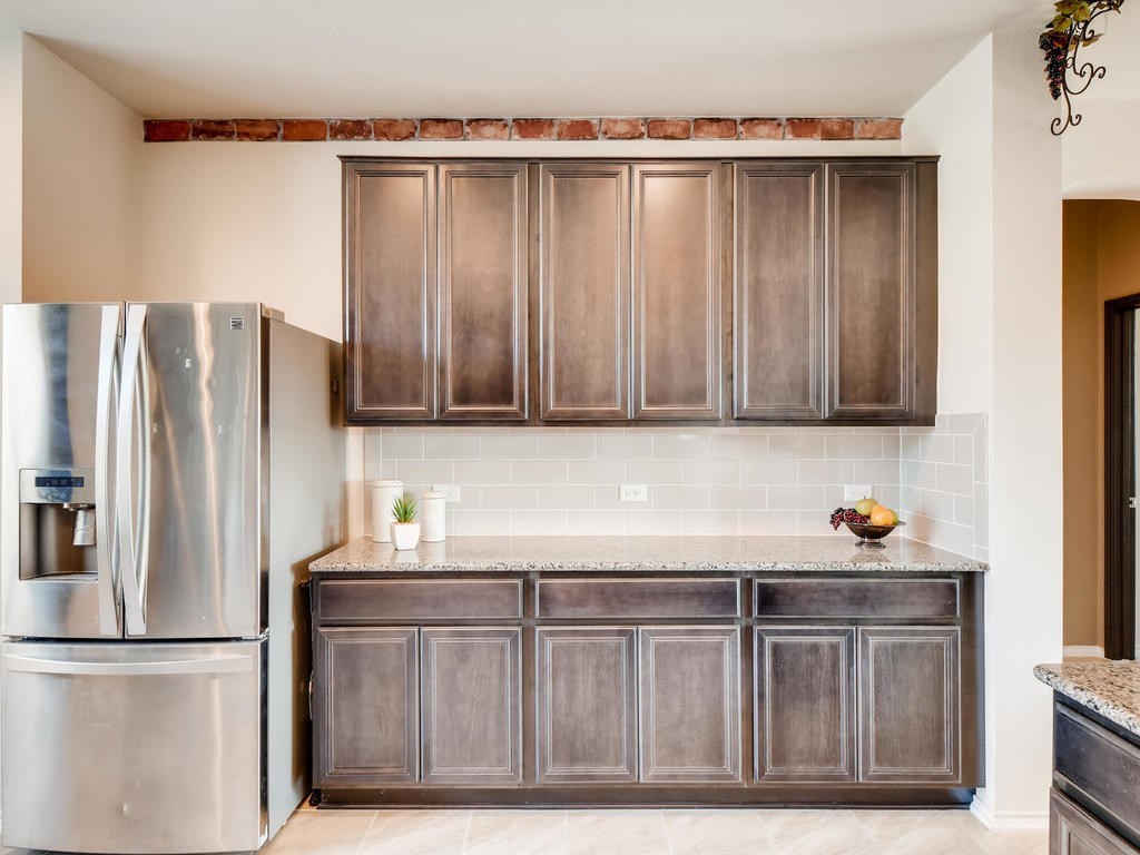 1301 Autumn Sage Way Pflugerville, TX 78660 - Photo 23 of 28 a kitchen with stainless steel appliances granite countertop a refrigerator and a sink