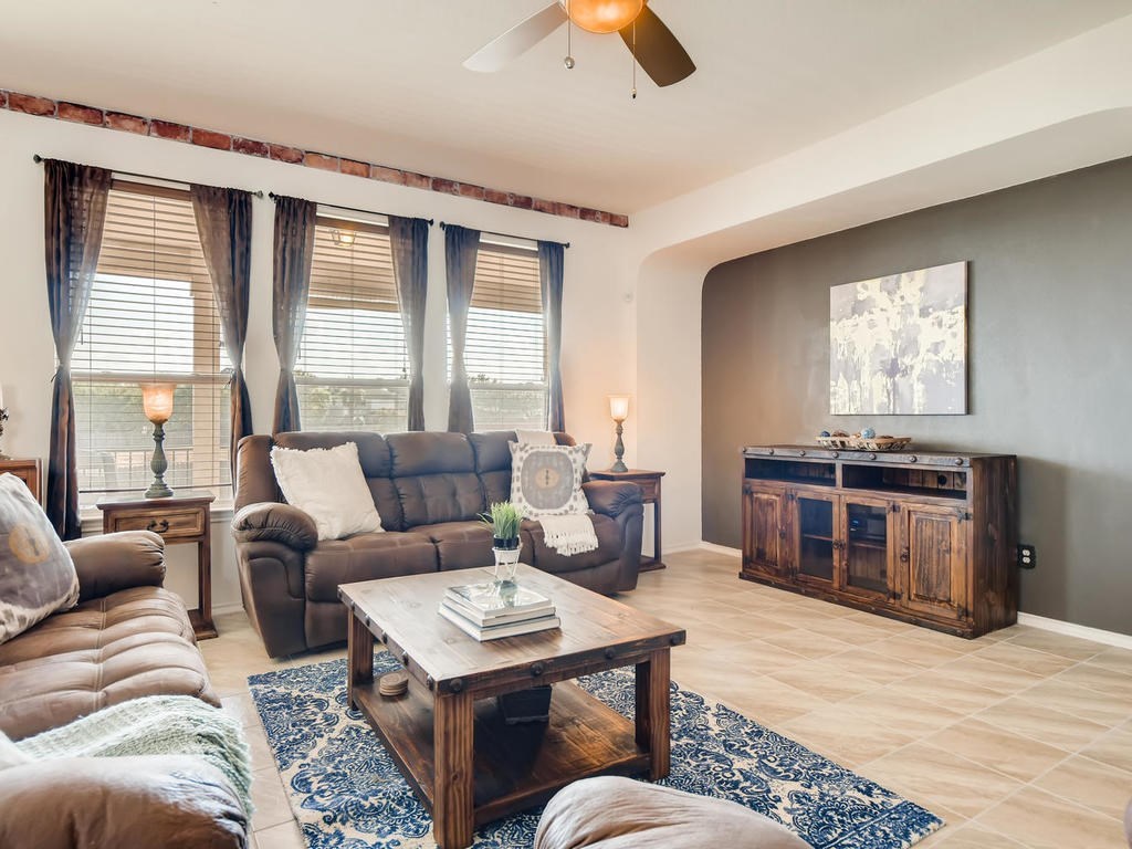 1301 Autumn Sage Way Pflugerville, TX 78660 - Photo 24 of 28 a living room with furniture and a flat screen tv