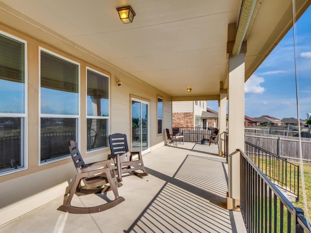 1301 Autumn Sage Way Pflugerville, TX 78660 - Photo 25 of 28 a view of a patio with a dining table and chairs with wooden floor