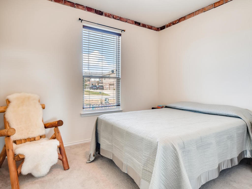 1301 Autumn Sage Way Pflugerville, TX 78660 - Photo 10 of 28 a bedroom with a bed and a window