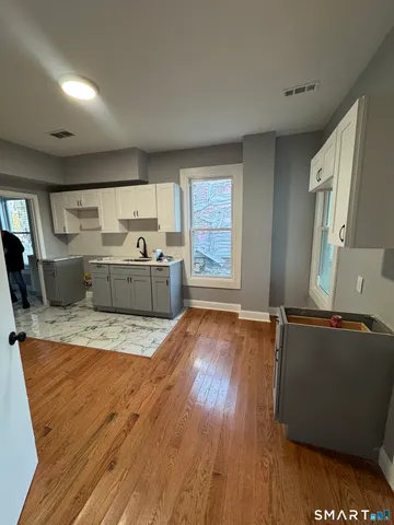 a room with wooden floors and couch