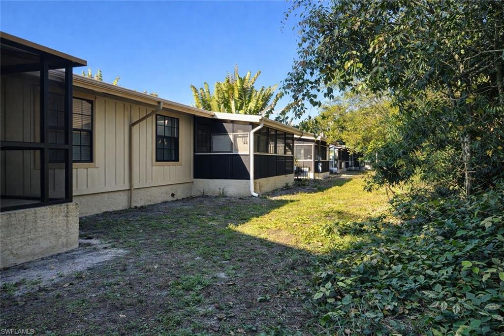 5324 Treetops Drive, Unit G2 Naples, FL 34113 - Photo 2 of 6 View of grassy yard featuring a sunroom