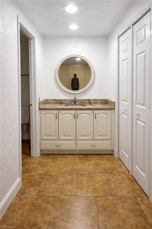 5324 Treetops Drive, Unit G2 Naples, FL 34113 - Photo 4 of 6 Bathroom featuring vanity and a closet