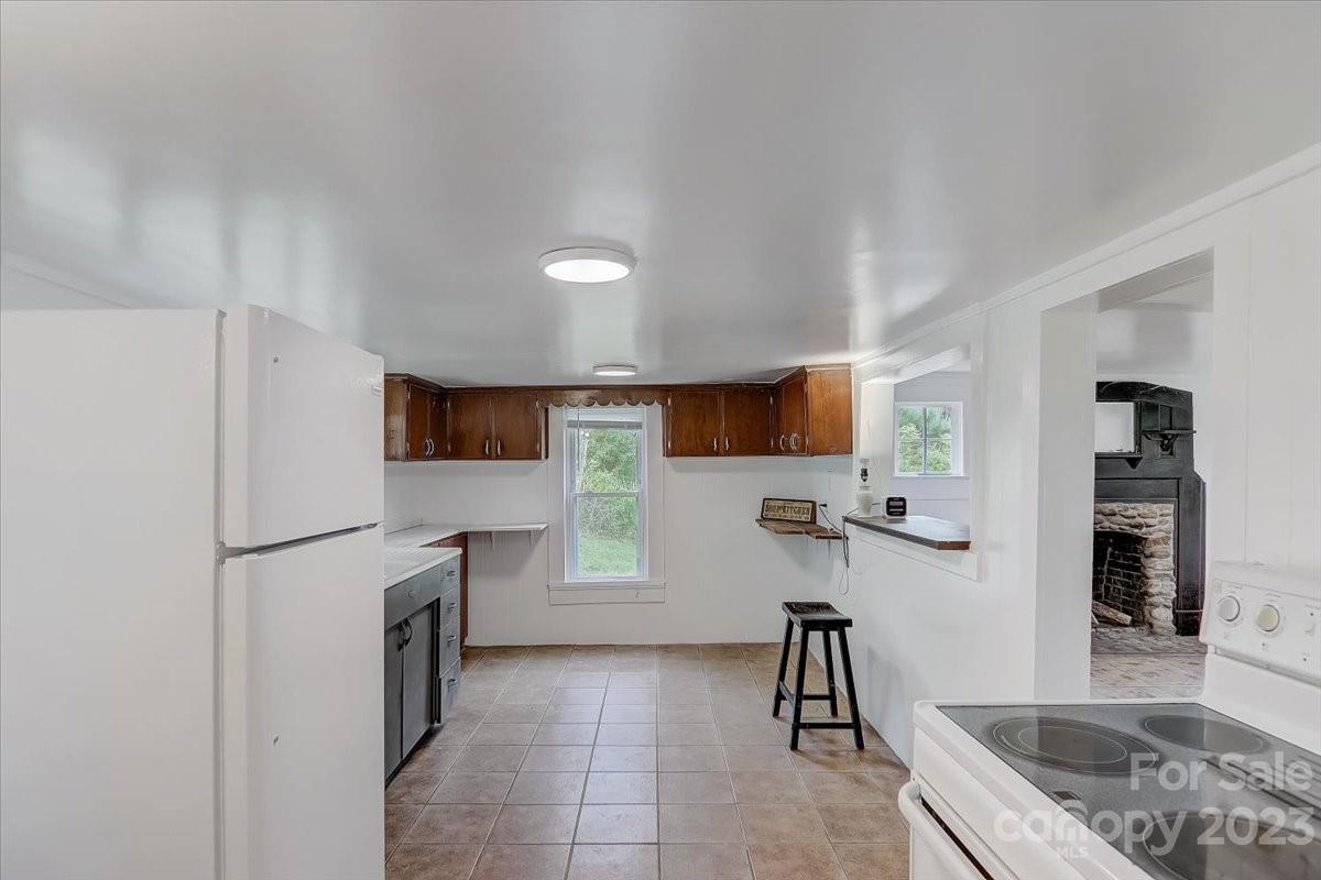 214 Plank Road Canton, NC 28716 - Photo 14 of 27 a kitchen with stainless steel appliances granite countertop a refrigerator sink and cabinets
