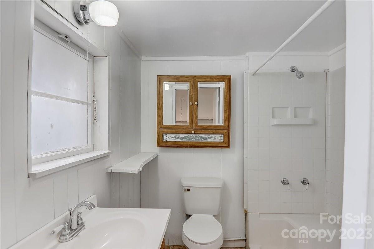 214 Plank Road Canton, NC 28716 - Photo 20 of 27 a bathroom with a toilet sink and mirror