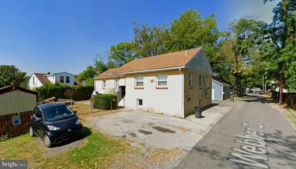 a view of a house with a yard siting area and garden