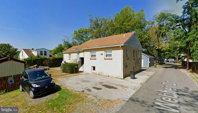 a view of a house with a yard siting area and garden